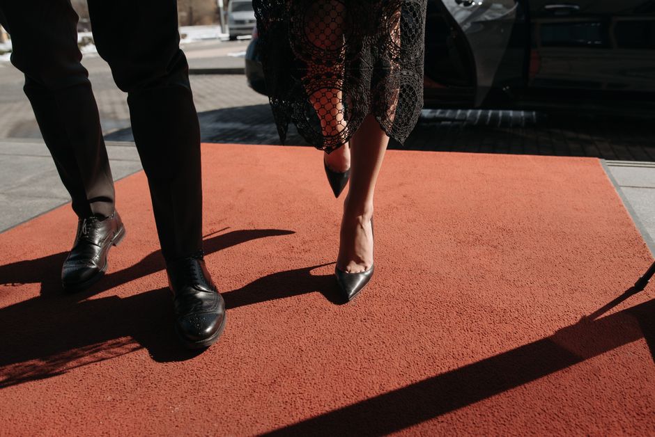 Stylish couple on red carpet, showcasing fashion and elegance at a prestigious event.